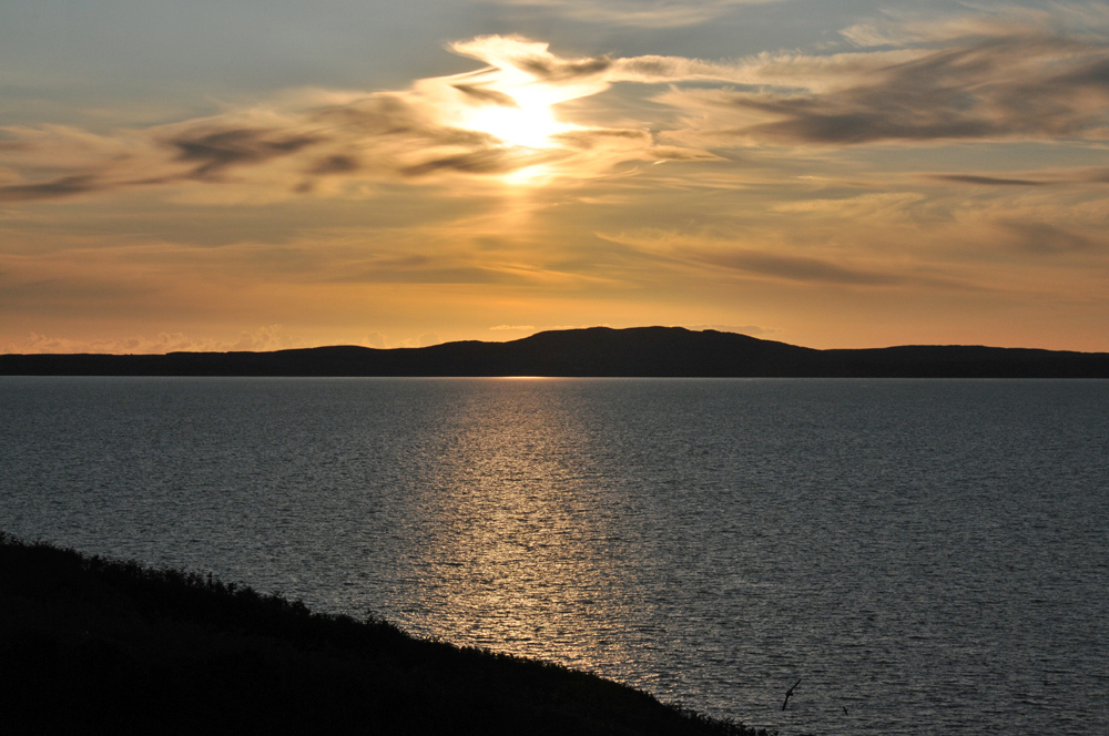 Picture of a view over a sea loch not long before a hazy sunset