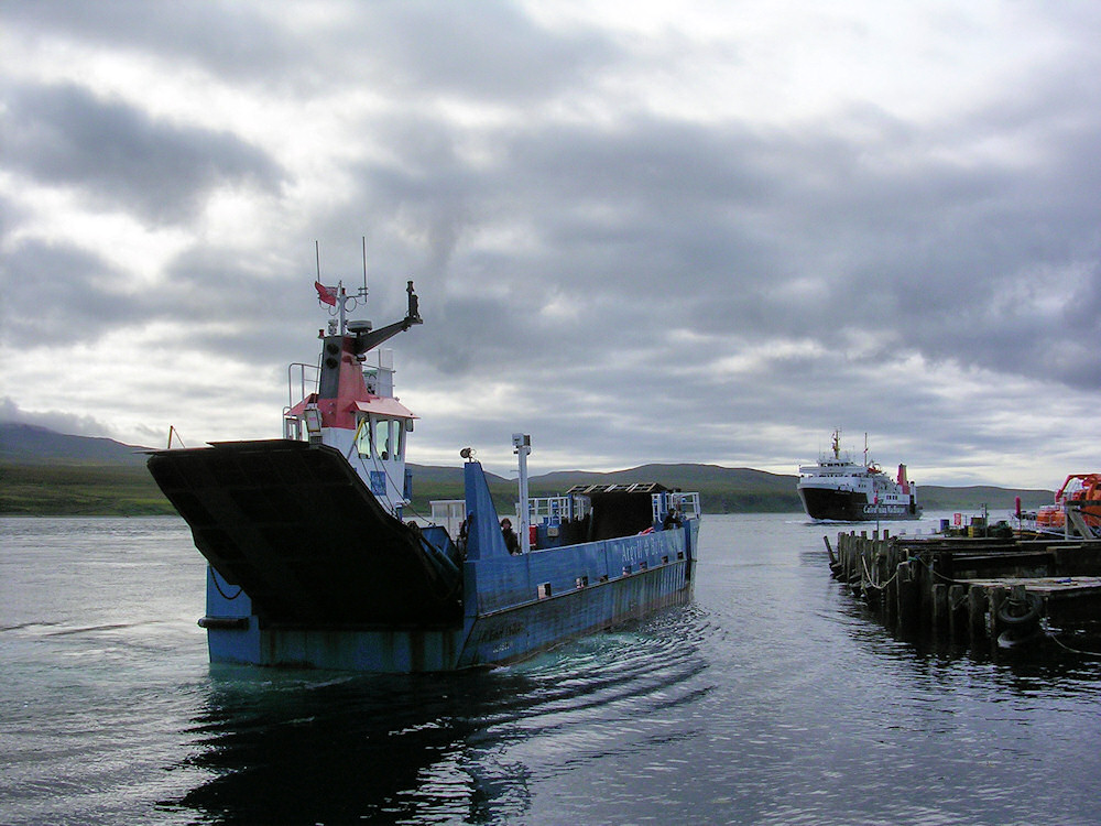 Picture of two ferries at a small harbour, a small car ferry and a large car ferry