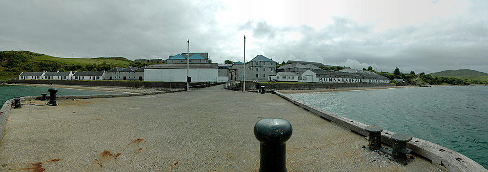 Panoramic picture of a coastal distillery seen from its pier