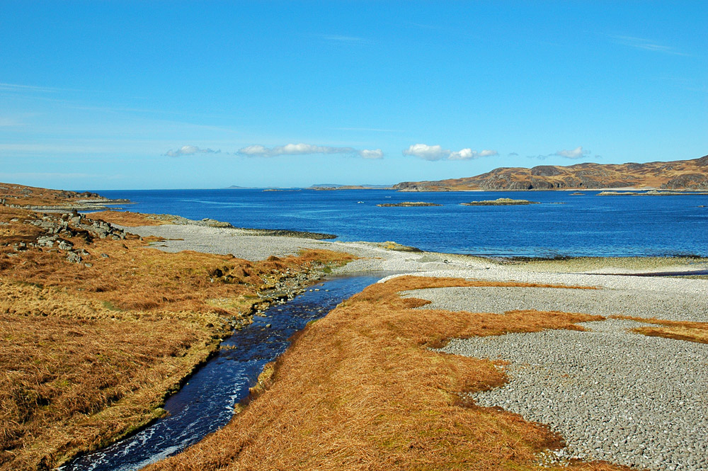 Picture of a view over a sea loch, a burn running into it