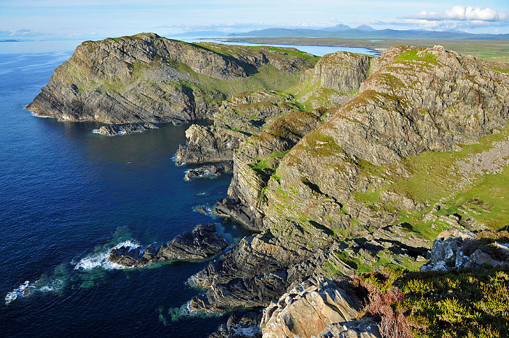 Picture of a series of high and steep cliffs at an island coastline