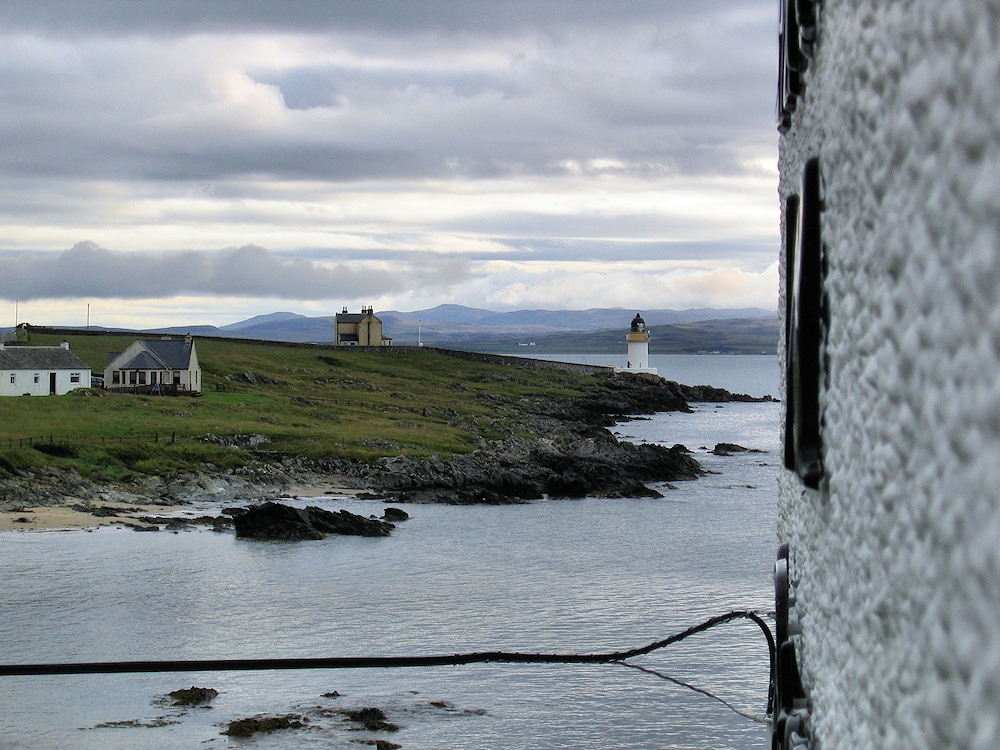 Picture of a view from a window towards a lighthouse