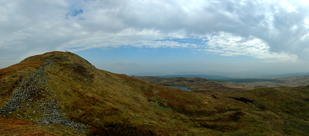 Panoramic picture of a hill and surrounding landscape on a hazy day