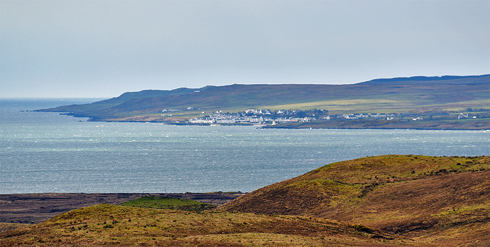 Picture of a coastal village seen across a sea loch