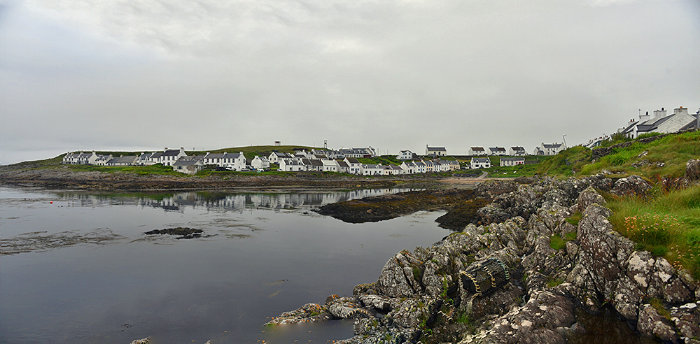 Picture of a coastal village around a bay on an overcast June evening