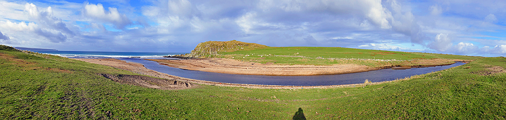 Panoramic picture of a small river flowing into a bay