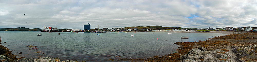 Panoramic picture of a coastal village around a small sea loch (bay)