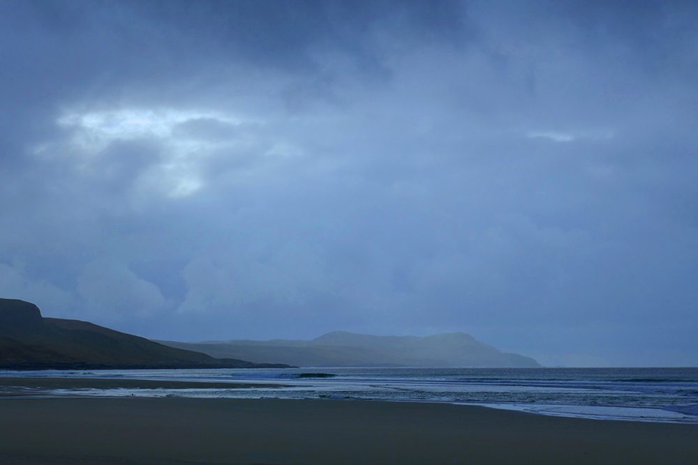 Picture of a bay with a beach on a showery day