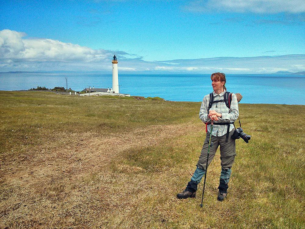 Picture of a woman standing in front of a lighthouse
