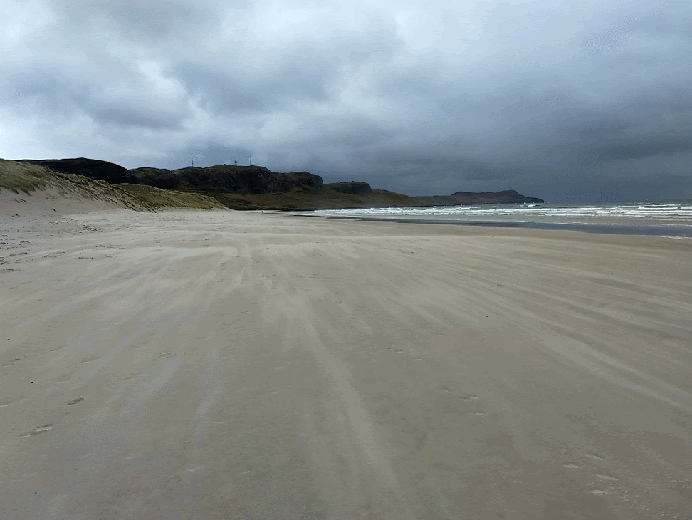Animated picture of sand blowing along a beach at high speed