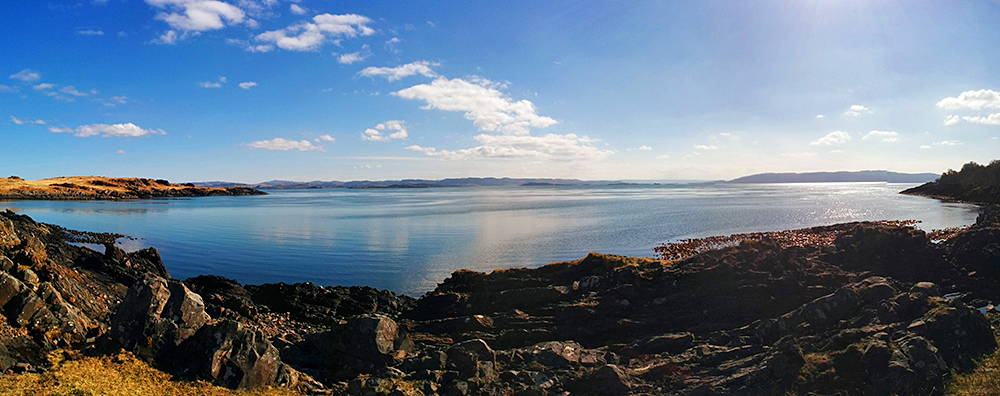 Panoramic picture of a rocky coastline at a small bay in a remote location