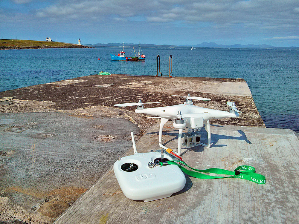 Picture of a drone and a remote control on a pier