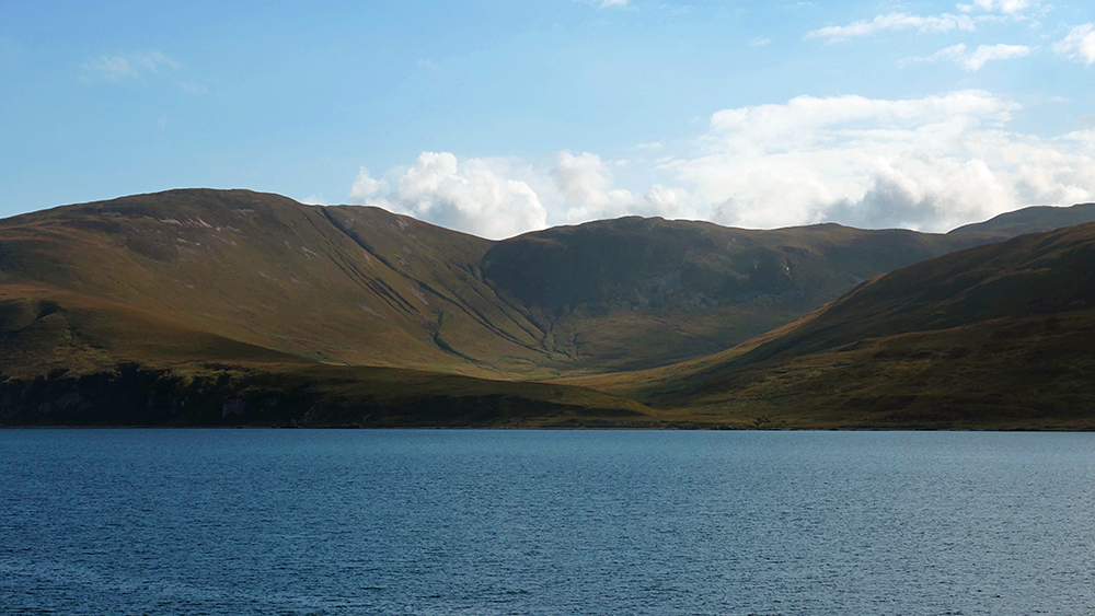 Picture of a wide glen next to a sound