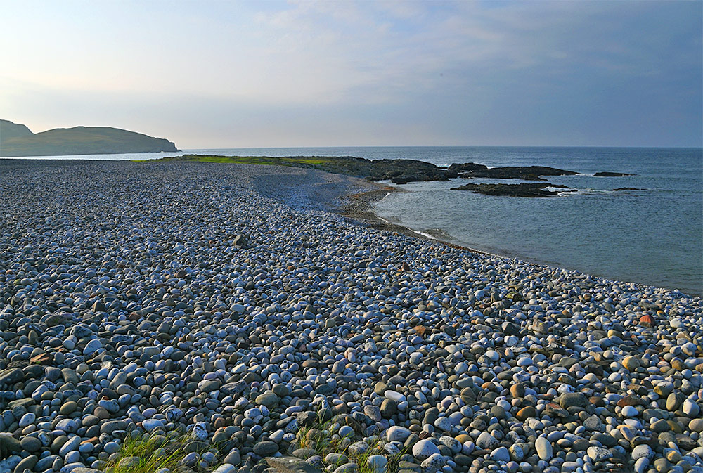 Picture of a pebble beach on a coast in the September afternoon sunshine