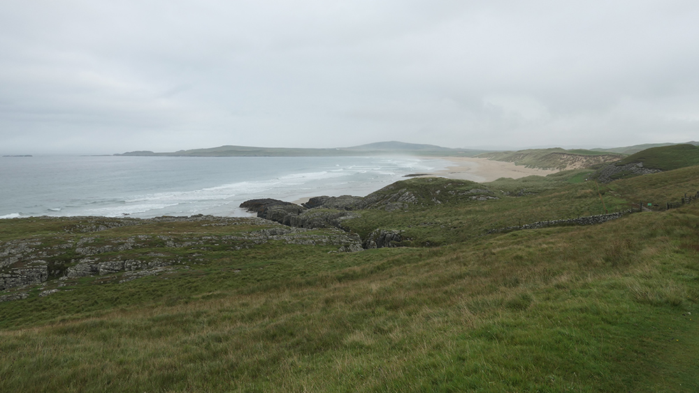 Picture of a wide bay with a sandy beach on a grey and damp day
