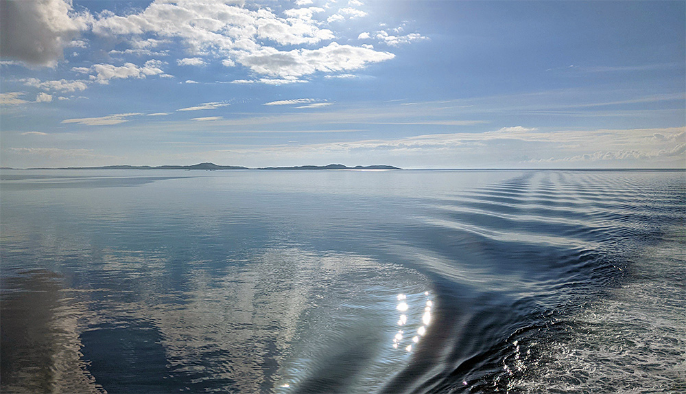 Picture of calm seas on a sunny day seen from a ferry