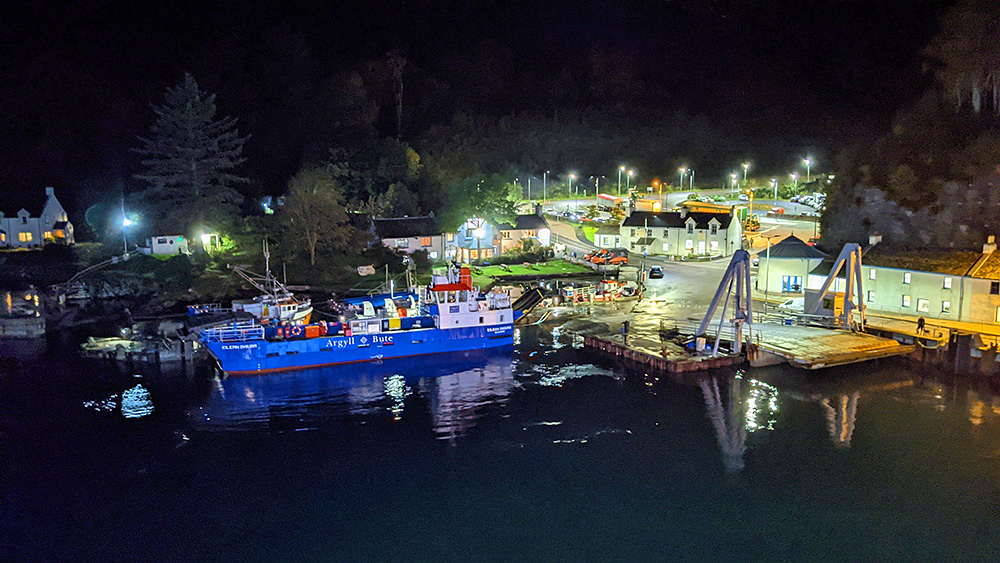 Picture of a small car ferry moored at a ferry slip in the evening