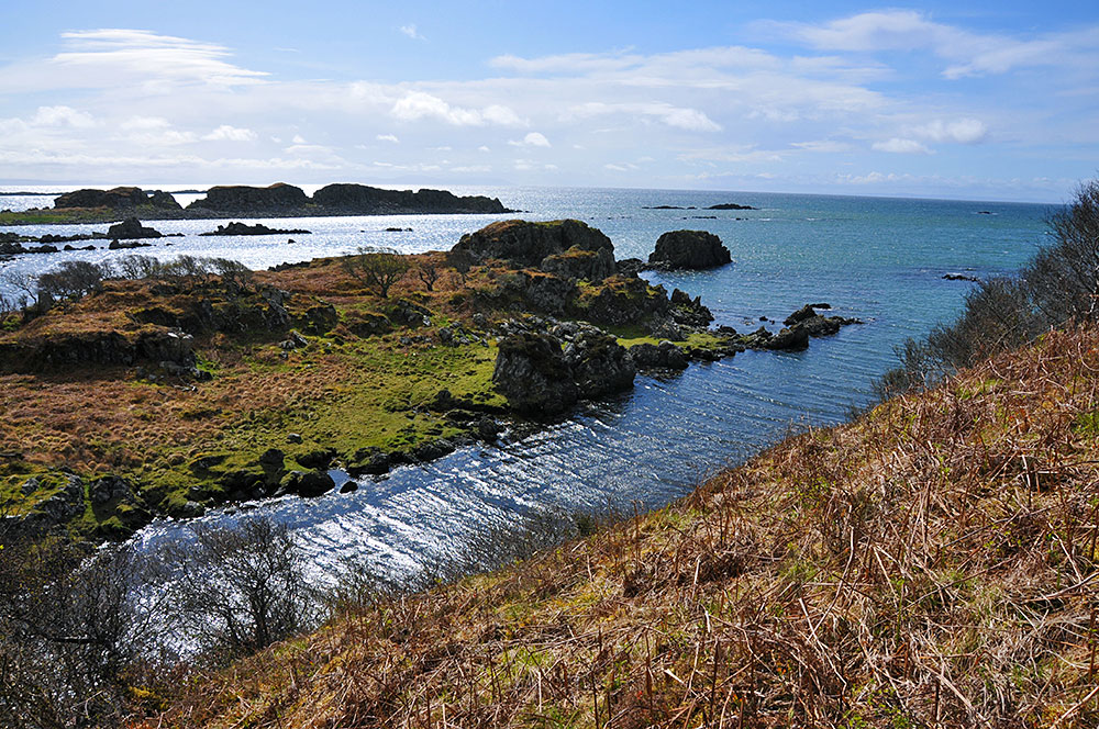 Picture of a rugged coastal landscape with some skerries in the background