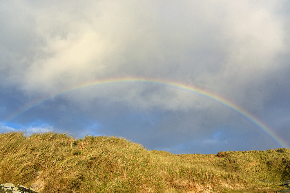 Picture of a rainbow above some dunes