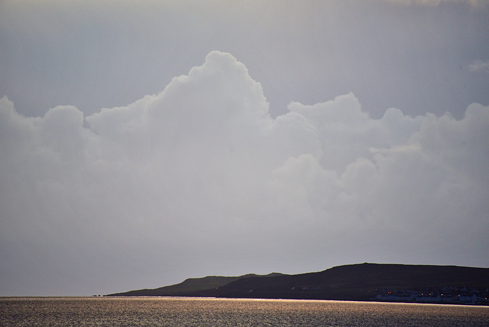 Picture of some nice clouds in interesting light above a coastal landscape