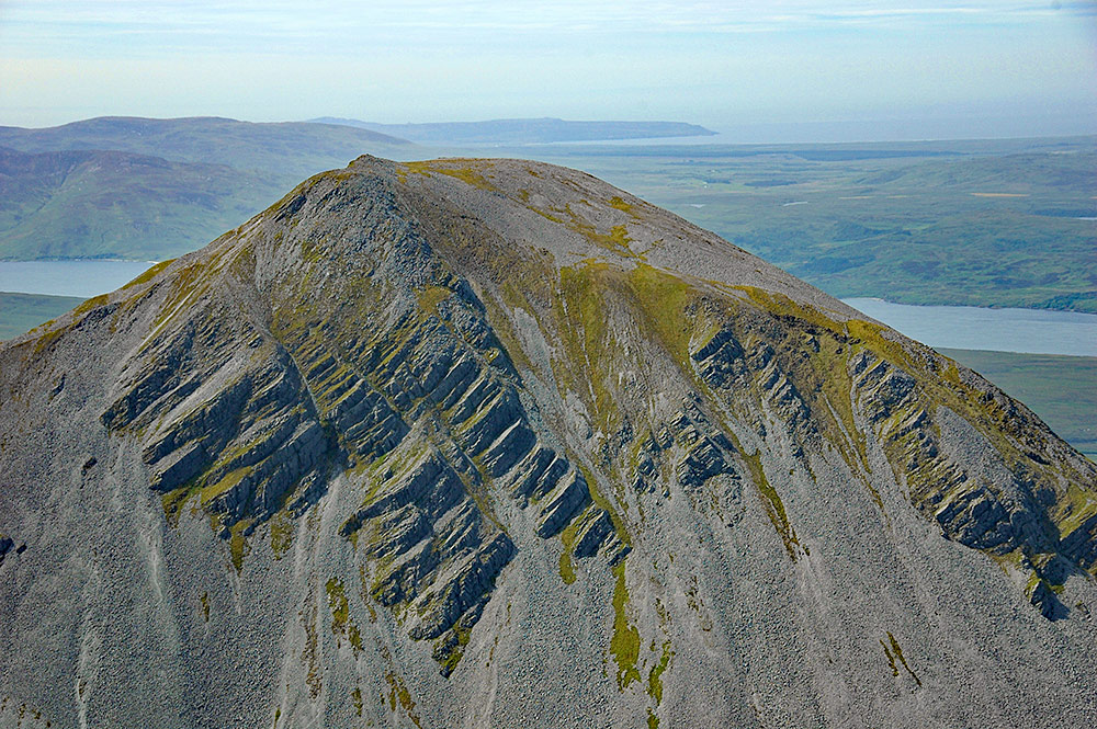 Picture of the summit of a mountain with steep slopes and scree