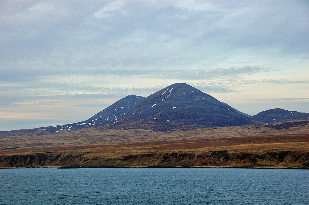 Picture of two mountains towering above a sound between two islands