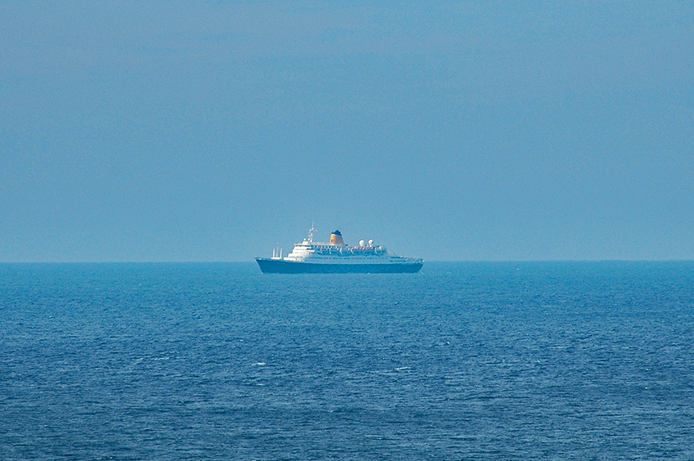 Picture of a small cruise ship out at sea on a sunny day