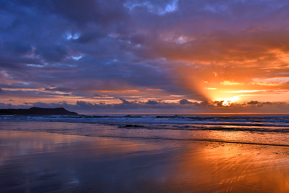 Picture of a dramatic cloudy sunset seen from a west coast beach