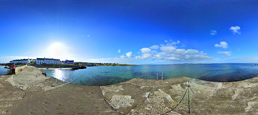 Panoramic 360° picture of a small pier in a sea loch off a small village