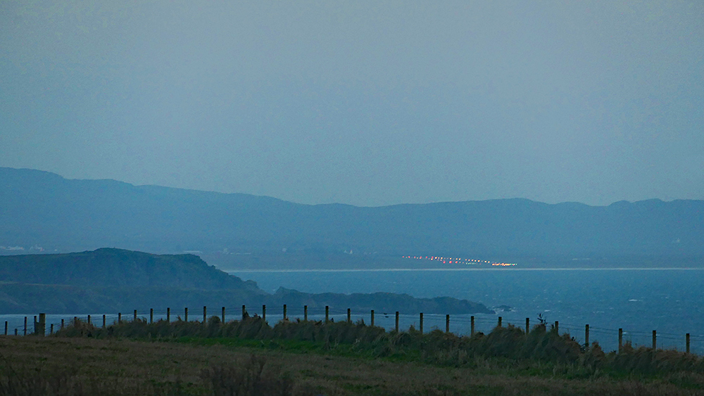 Picture of a view across a sea loch and a bay to an airport in the evening light