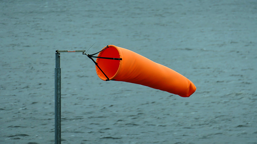 Picture of an orange wind sock on a pole