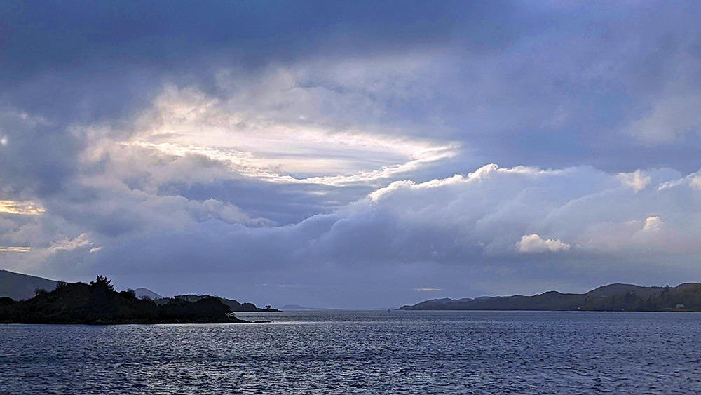 Picture of a view out of a sea loch with some dramatic clouds overhead