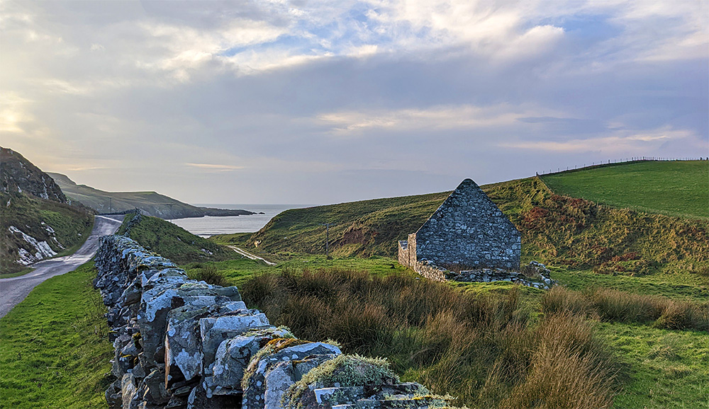 Picture of a chapel ruin above a small bay in some mild November afternoon sunshine