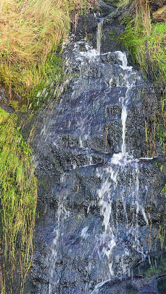 Picture of a small waterfall with water splashing up high