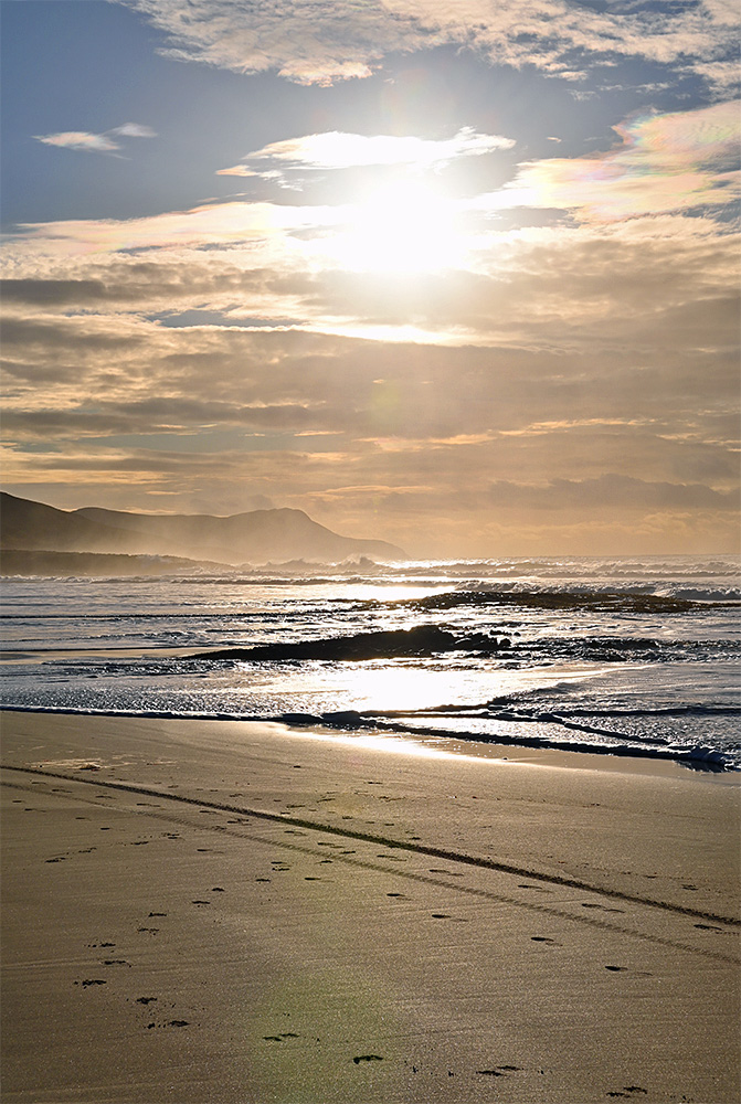 Picture of some low hazy November sunshine over a bay with a sandy beach