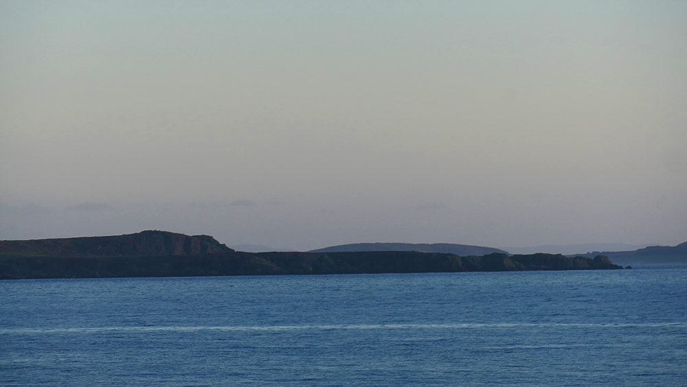 Picture of some cliffs seen across a sea loch