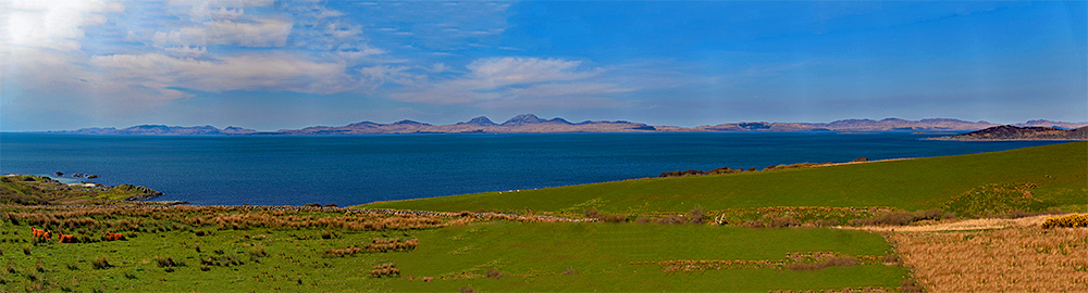 Panoramic picture of a view from the mainland to two islands, Islay and Jura
