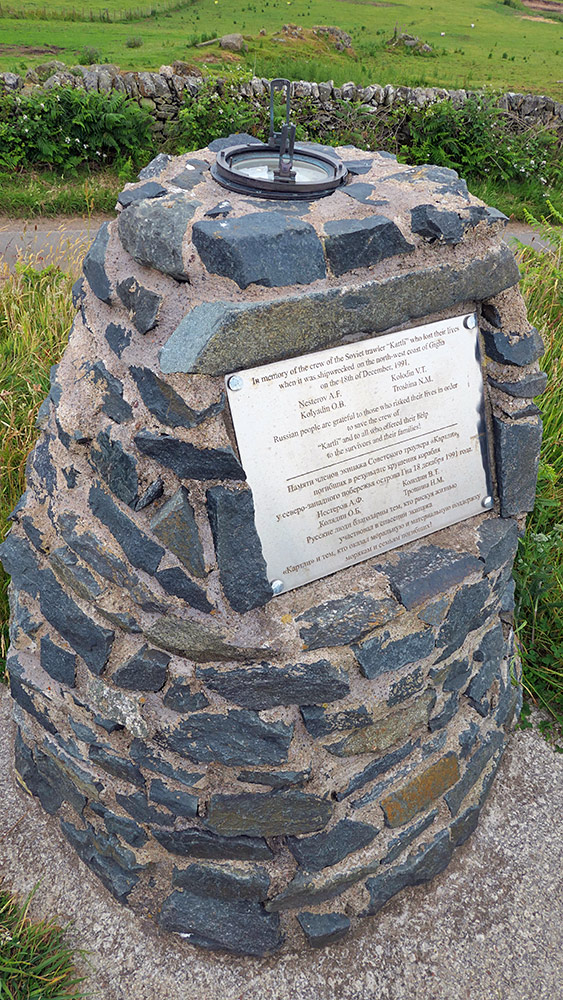 Picture of a memorial cairn with an old compass on top