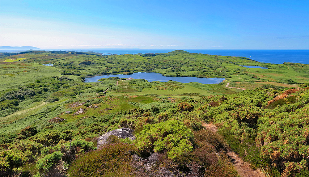 Picture of a view over a few lochs on an island from a hill on the island