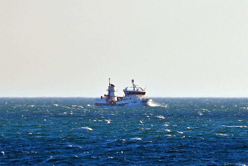 Picture of a ship (possibly a larger fishing vessel) out at sea