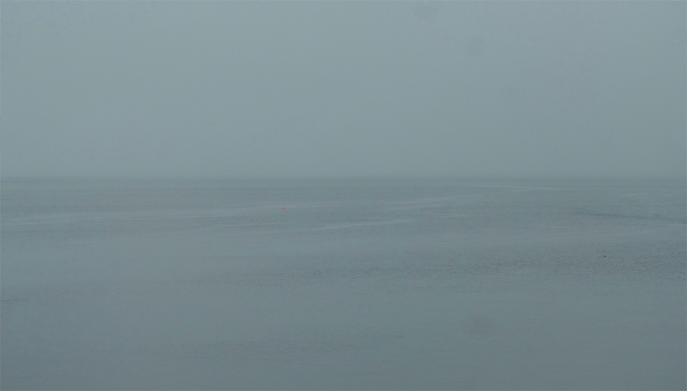 Picture of a view out to sea on a dull, grey and misty day