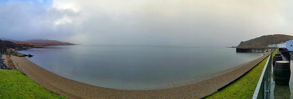 Panoramic picture of a view from a veranda over a sound between two islands on a grey and dreich November day