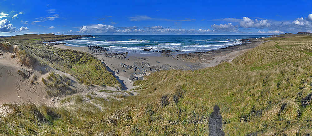 Panoramic picture of a wide bay seen from the top of dunes