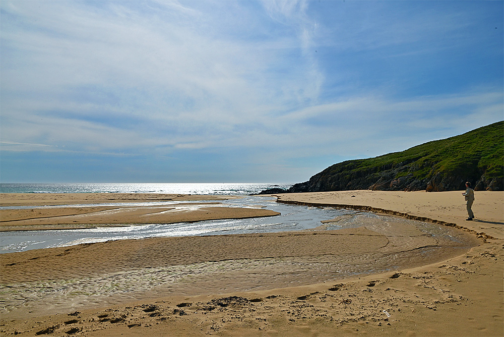 Picture of a stream meandering over a sandy beach on a sunny June afternoon