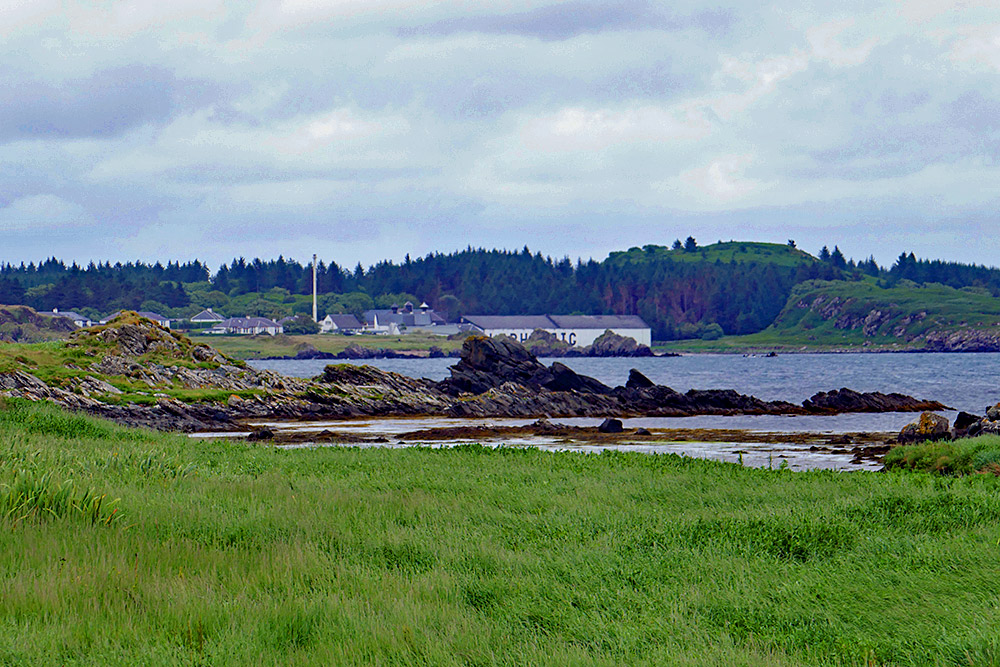 Picture of Laphroaig distillery seen across a coastal landscape