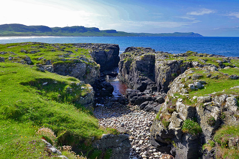 Picture of a rocky channel at the shore of a wide bay
