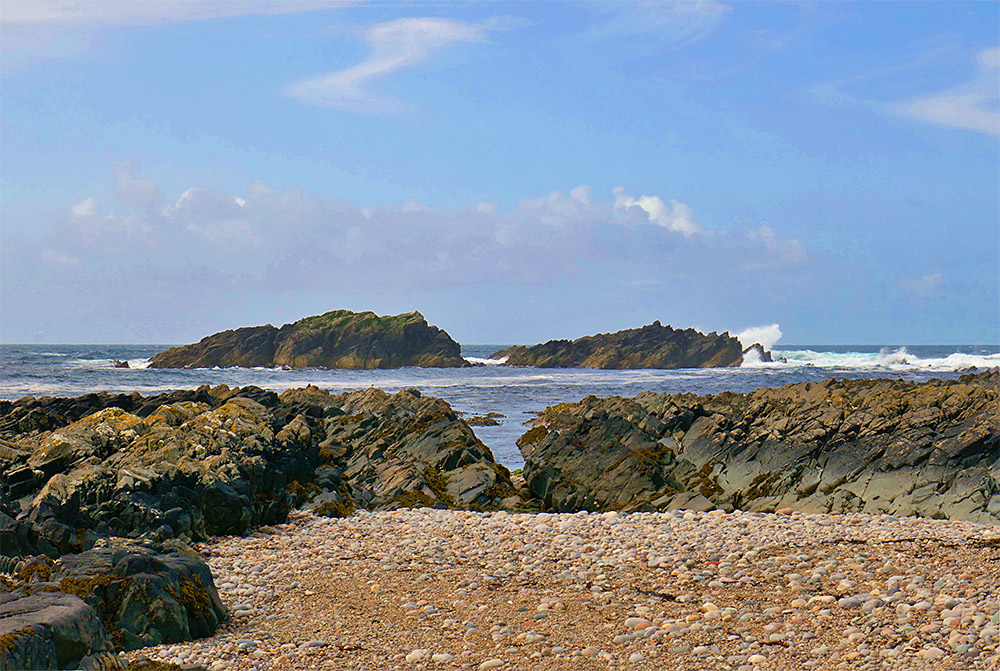 Picture of two rocky outcrops seen from a rocky shore
