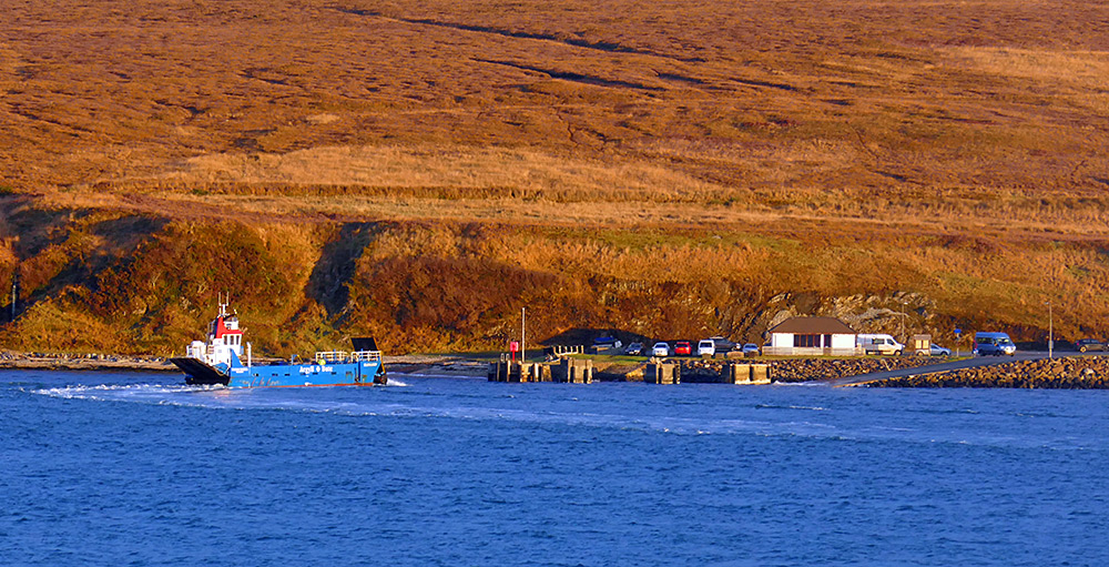 Picture of a small car ferry approaching a slipway