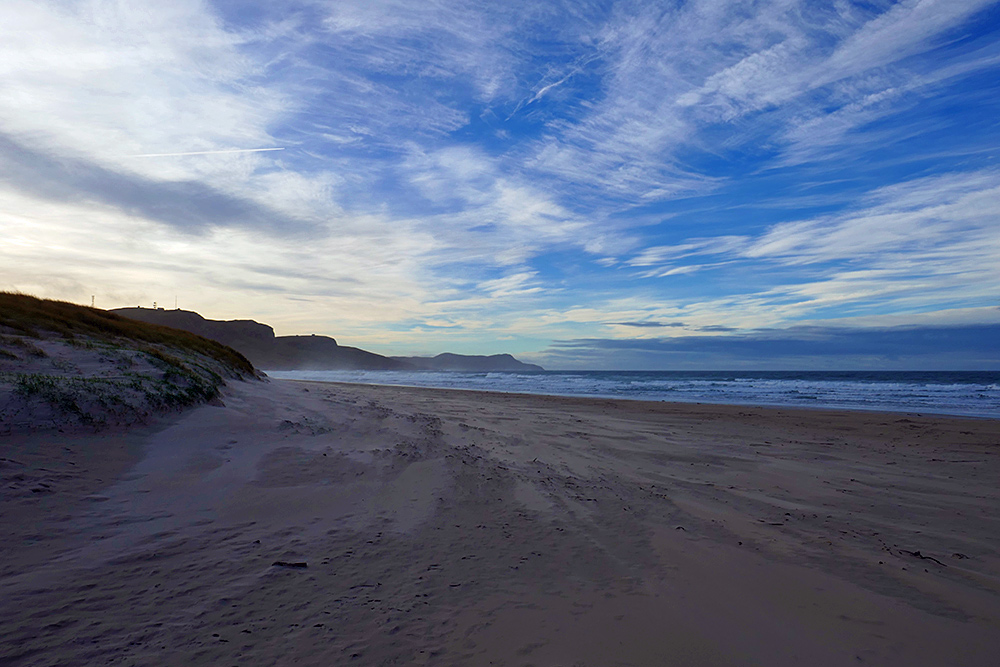 Picture of a view around a dune while walking out on to a sandy beach