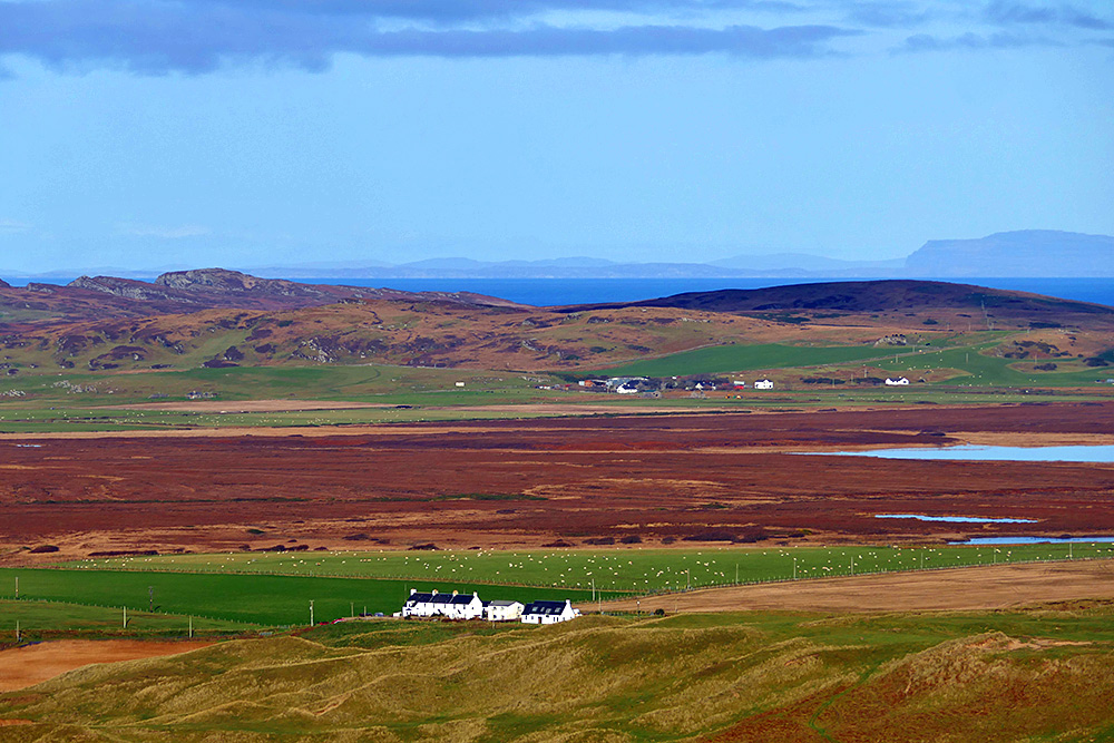Picture of a rural landscape on an island with a row of houses and a small farming settlement